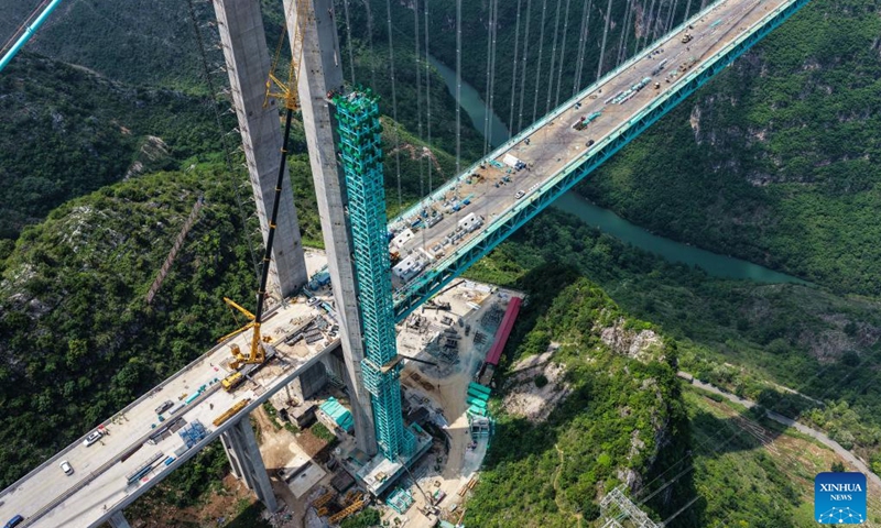 An aerial drone photo shows the installation of the sightseeing elevator at the construction site of the Huajiang Grand Canyon Bridge in southwest China's Guizhou Province, June 5, 2025. As workers started to remove the gantry cranes and install elevators, the construction of the Huajiang Grand Canyon Bridge, which is set to become the world's tallest bridge, is expected to complete in the second half of 2025. (Photo: Xinhua)