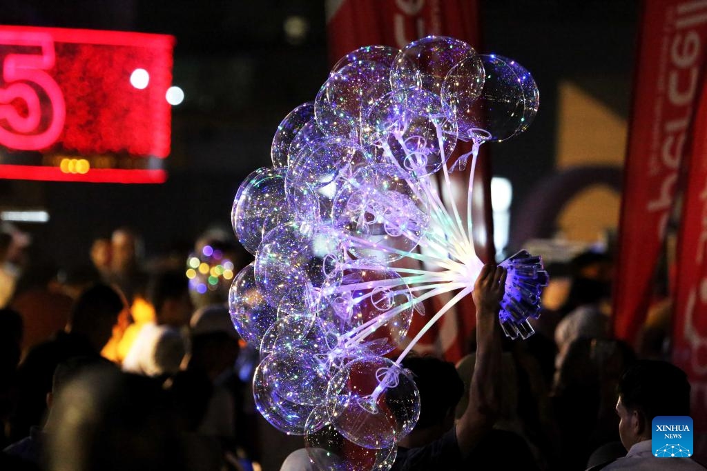 A man holds illuminated balloons during Eid al-Adha in Baghdad, Iraq, on June 7, 2025. (Photo: Xinhua)
