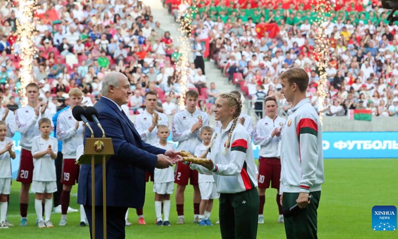 Belarusian President Alexander Lukashenko (L, front) hands the key, a symbol of the Belarusian National Football Stadium project built with Chinese support, to representatives of Belarusian athletes in Minsk, Belarus, June 7, 2025. The Belarusian National Football Stadium officially opened here on Saturday evening, with President Alexander Lukashenko attending the inauguration ceremony. As the largest and most modern football stadium in Belarus, it meets the highest international standards. With a seating capacity of over 33,000, the stadium was constructed under a general contract by Beijing Urban Construction Group, said the president. (Photo: Xinhua)
