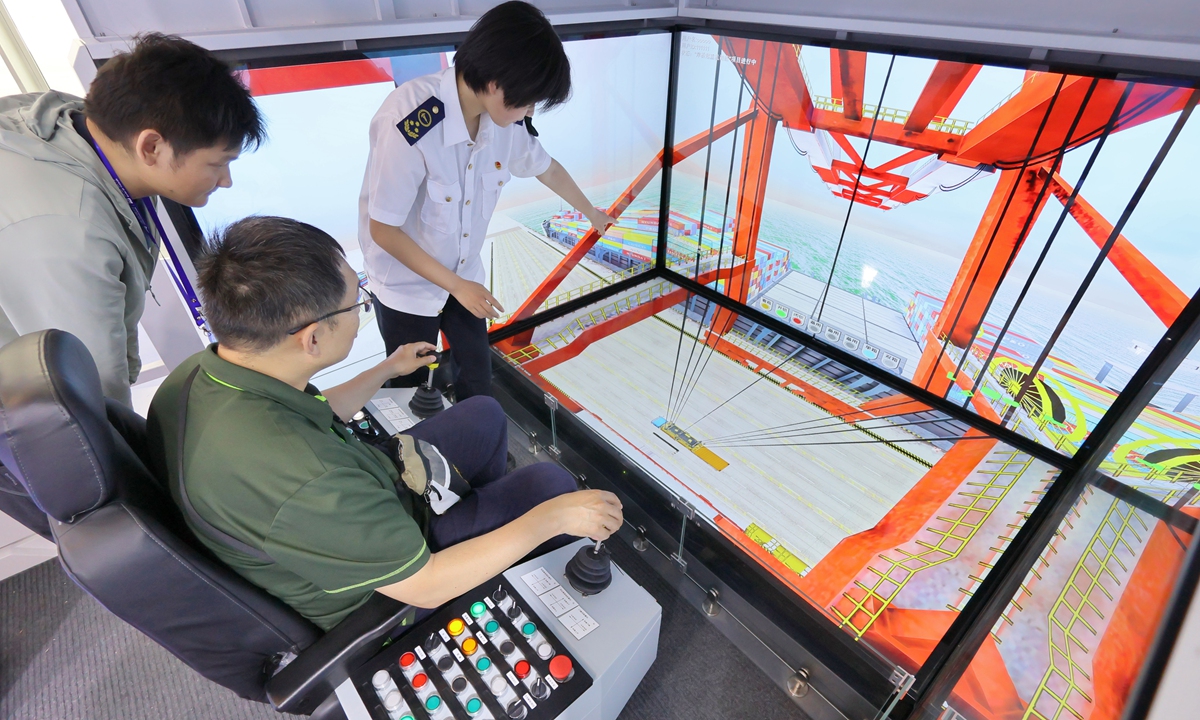 A visitor tries a remote-controlled container simulator at the 3rd Tianjin International Shipping Industry Expo in North China's Tianjin Municipality on June 12, 2025. The event showcases global cooperation and innovation in shipping, with the number of attendees expected to hit 80,000, up more than 15 percent from last year. Photo: VCG