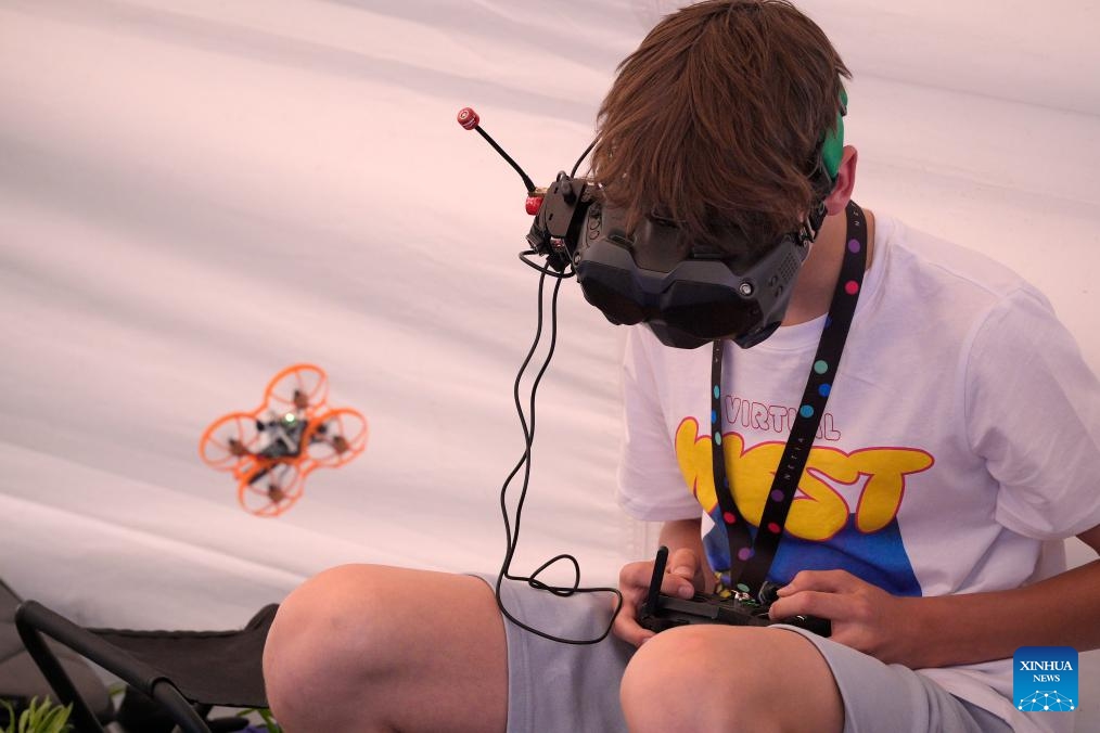 A teenager wearing goggles operates a first-person view (FPV) drone during the Drone Picnic in Warsaw, Poland on June 14, 2025. (Photo: Xinhua)