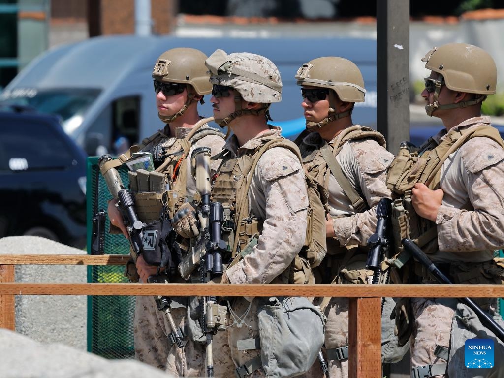 U.S. Marines stand guard at the entrance of the Wilshire Federal Building in Los Angeles, California, the United States, on June 13, 2025. About 200 U.S. marines have been deployed to Los Angeles, the second largest city in the United States, to protect a federal building there, the military said on Friday, after a week of protests over the current administration's immigration raids in the city. (Photo: Xinhua)