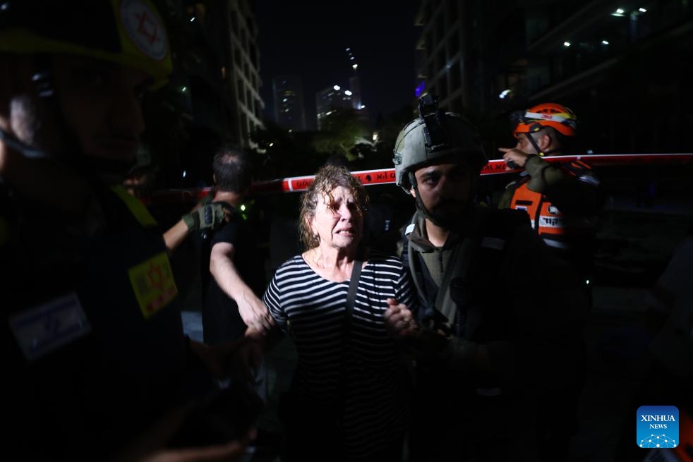 A resident is seen evacuated from a building damaged by missiles fired from Iran in central Israel, on June 13, 2025. Three Israelis were killed and 172 others injured in rocket barrages launched from Iran on Friday night and early Saturday morning, according to Israel's state-owned Kan TV News. According to the Israeli army, Iran launched hundreds of missiles in five barrages during the assaults. (Photo: Xinhua)