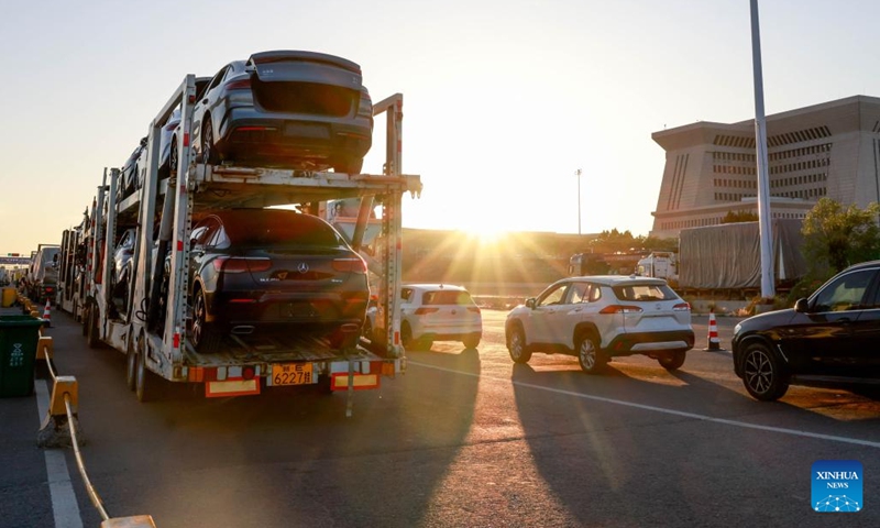 This photo taken on May 27, 2025 shows vehicles waiting for inspection and release at the road port of Horgos, northwest China's Xijiang Uygur Autonomous Region. As the largest land port for automobile exports in China, Horgos Port has implemented a 24-hour freight clearance system, working 7 days a week, to enhance trade logistics. According to statistics from Horgos Customs, the port had exported about 421,000 vehicles in 2024, reaching a new record high. (Photo: Xinhua)