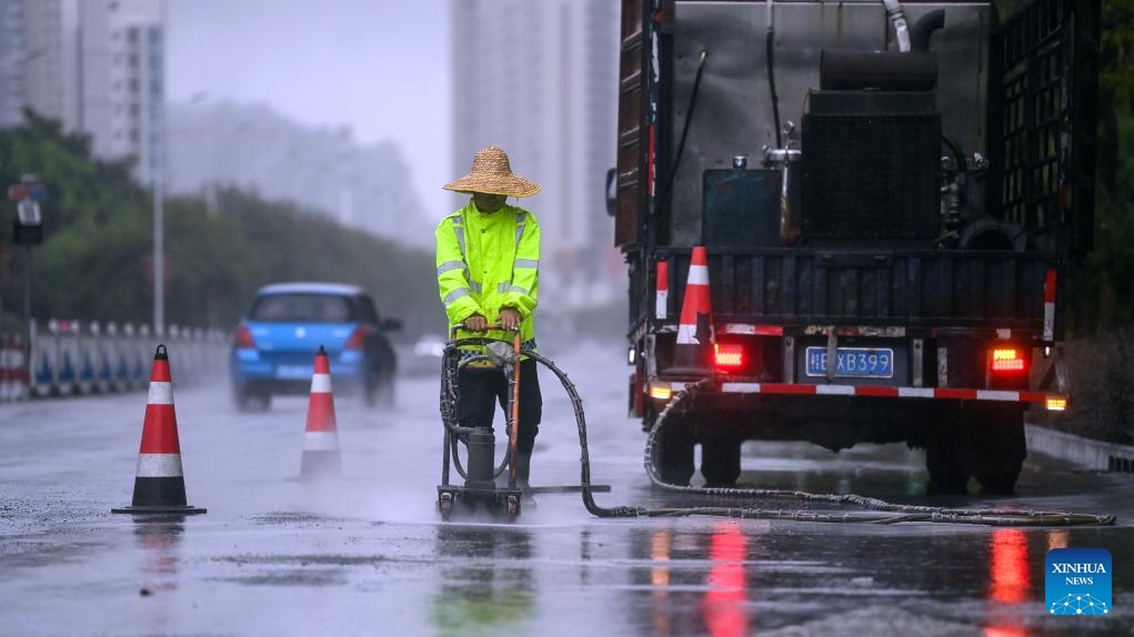 A worker repairs damaged road surface amid heavy rainfall in Beihai City, south China's Guangxi Zhuang Autonomous Region, June 14, 2025. Multiple Chinese authorities convened on Saturday to put in place precautionary measures against Typhoon Wutip, the first typhoon of the year, which is expected to bring heavy rainfall to the southern parts of the country. (Photo: Xinhua)