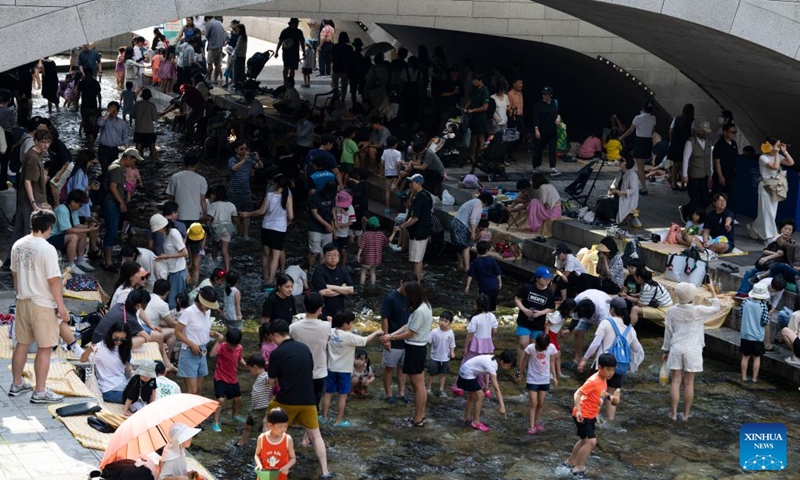 People cool themselves off at the Cheonggye stream, in Seoul, South Korea, June 14, 2025. (Photo: Xinhua)