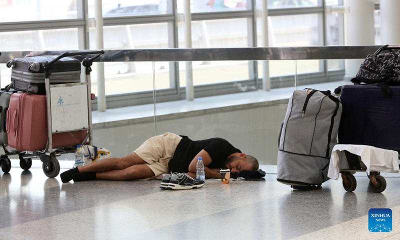 A traveler waits for his flight at an airport in Beirut, Lebanon, on June 14, 2025. Lebanese Minister of Public Works and Transport Fayez Rasamny announced on Saturday the reopening of Beirut Airport, which had been closed since 10 p.m. (1900 GMT) the previous day amid escalating regional tensions following the exchange of strikes between Israel and Iran. The state-run National News Agency (NNA) reported congestion in the airport's departure hall as operations resumed, with authorities working to ease crowding and restore order. (Photo: Xinhua)