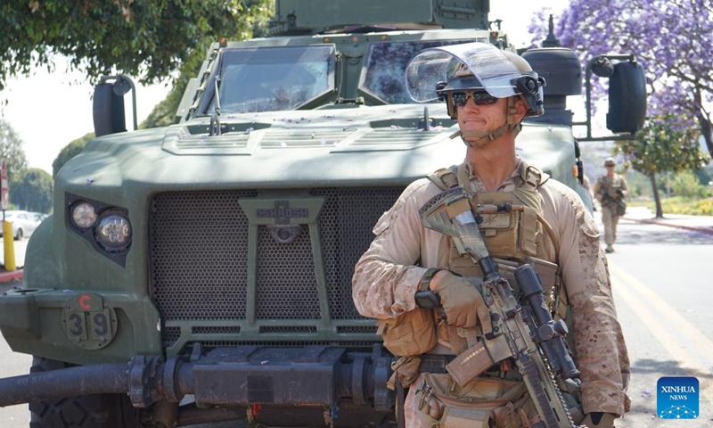 A U.S. Marine stands guard at the entrance of the Wilshire Federal Building in Los Angeles, California, the United States, on June 13, 2025. About 200 U.S. marines have been deployed to Los Angeles, the second largest city in the United States, to protect a federal building there, the military said on Friday, after a week of protests over the current administration's immigration raids in the city. (Photo: Xinhua)
