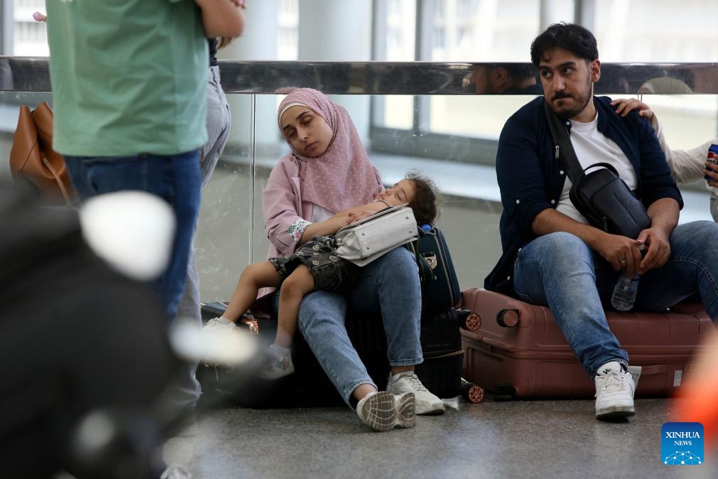 Travelers wait for their flights at an airport in Beirut, Lebanon, on June 14, 2025. Lebanese Minister of Public Works and Transport Fayez Rasamny announced on Saturday the reopening of Beirut Airport, which had been closed since 10 p.m. (1900 GMT) the previous day amid escalating regional tensions following the exchange of strikes between Israel and Iran. The state-run National News Agency (NNA) reported congestion in the airport's departure hall as operations resumed, with authorities working to ease crowding and restore order. (Photo: Xinhua)
