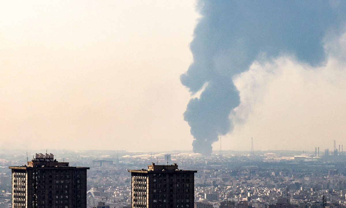 A plume of heavy smoke rises over an oil refinery in southern of Tehran, after it was hit in an overnight Israeli strike, on June 15, 2025.?