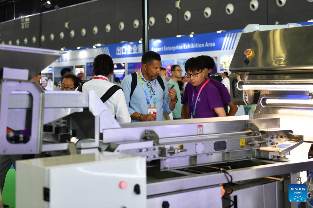 A visitor (C) learns about a grain sorting machine during the fourth China-Africa Economic and Trade Expo at Changsha International Convention and Exhibition Center in Changsha, central China's Hunan Province, June 14, 2025. The fourth China-Africa Economic and Trade Expo opened Thursday in the central Chinese city of Changsha, highlighting the commitment of the world's largest developing country to strengthening ties with Africa, the continent with the largest number of developing nations. (Photo: Xinhua)
