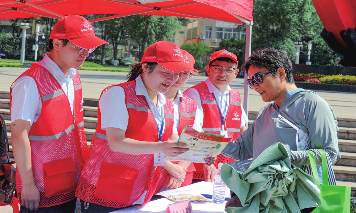 Staff members promote laws and regulations on production safety to a community resident in Hefei, East China's Anhui Province, on June 16, 2025. This June marks China's 24th National Safety Production Month. Photo: VCG