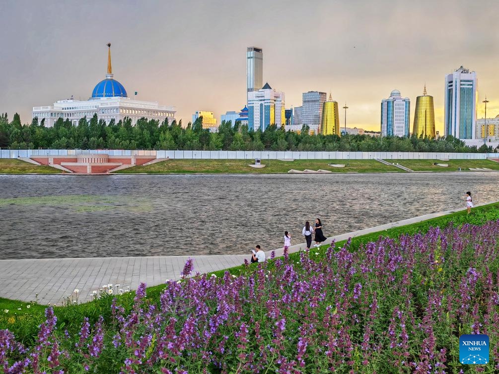 People enjoy leisure time by the Ishim River in Astana, Kazakhstan, June 13, 2025. (Photo: Xinhua)