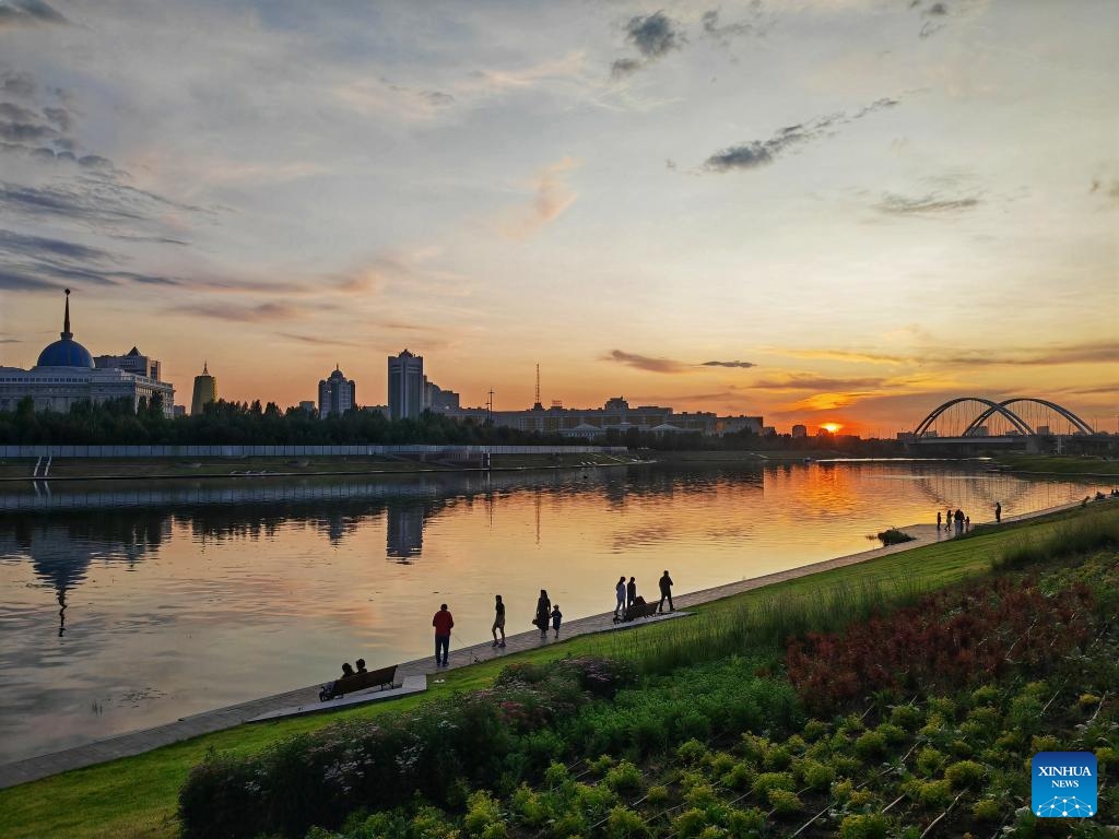 People enjoy leisure time by the Ishim River in Astana, Kazakhstan, June 12, 2025. (Photo: Xinhua)