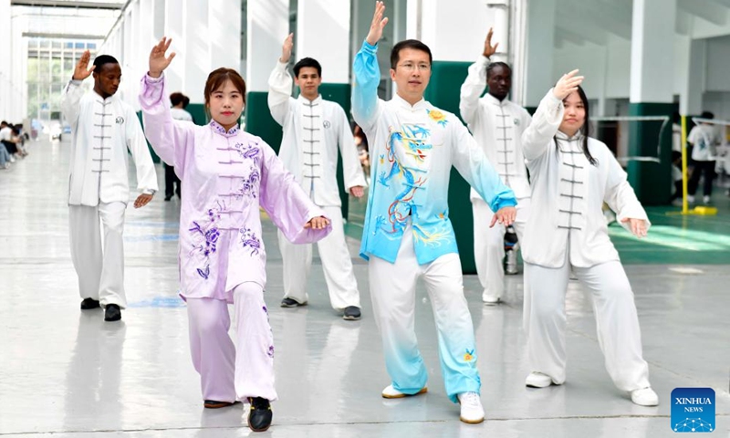 Zeela Nebulani (2nd L) practices Tai Chi following a teacher's instruction at the Rizhao Polytechnic in Rizhao City, east China's Shandong Province, May 23, 2025. Born into an Indonesian family with a martial arts pedigree, Zeela Nebulani began training at the age of six. In May 2024, she traveled to the Daqingshan Tai Chi research base in the city of Rizhao to study the Chen-style Tai Chi moves. During her stay, she visited Rizhao Polytechnic, where the idea of studying abroad took root. (Photo: Xinhua)