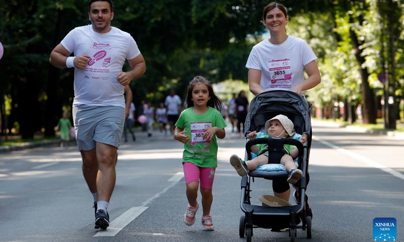 Participants run during the Race for the Cure, a part of an international fund-raising event aiming to fight breast cancer, in Bucharest, Romania, June 15, 2025. (Photo: Xinhua)