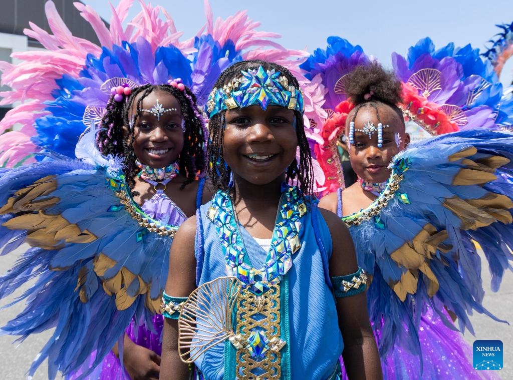 Dressed-up children pose for photos during the official launch ceremony of the 2025 Toronto Caribbean Carnival in Toronto, Canada, on June 14, 2025. (Photo: Xinhua)