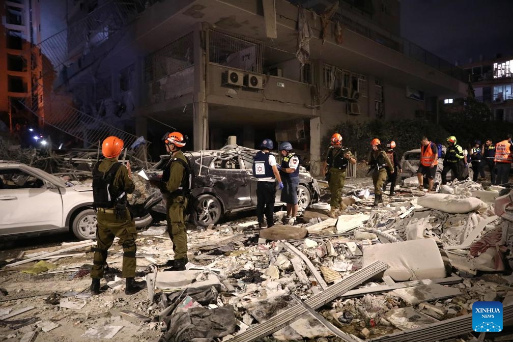 Israeli first responders work at a site hit by a missile fired from Iran in Bat Yam, south of Tel Aviv, Israel, June 15, 2025. Iranian aerial attacks killed at least six people and injured 140 others in Israel early on Sunday, Israeli authorities said. (Photo: Xinhua)