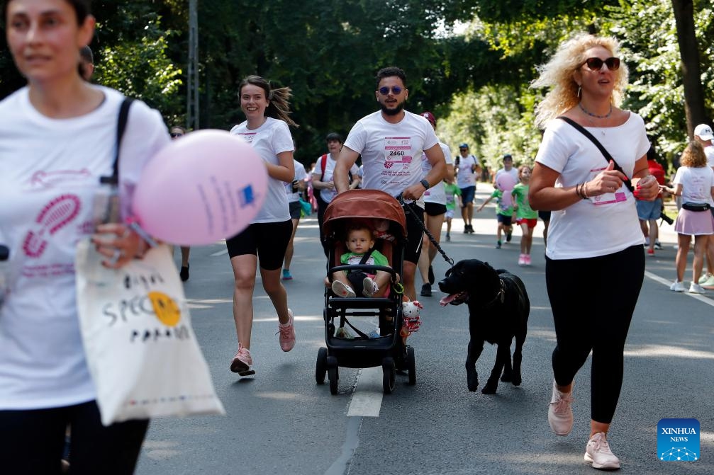 Participants run during the Race for the Cure, a part of an international fund-raising event aiming to fight breast cancer, in Bucharest, Romania, June 15, 2025. (Photo: Xinhua)