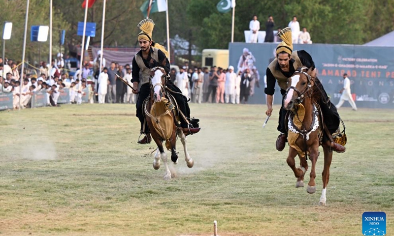 Horsemen compete during a tent pegging competition in Islamabad, capital of Pakistan on June 14, 2025. In tent pegging, a horseman gallops and uses a sword or a lance to pierce, pick up and carry away a wooden peg. (Photo: Xinhua)