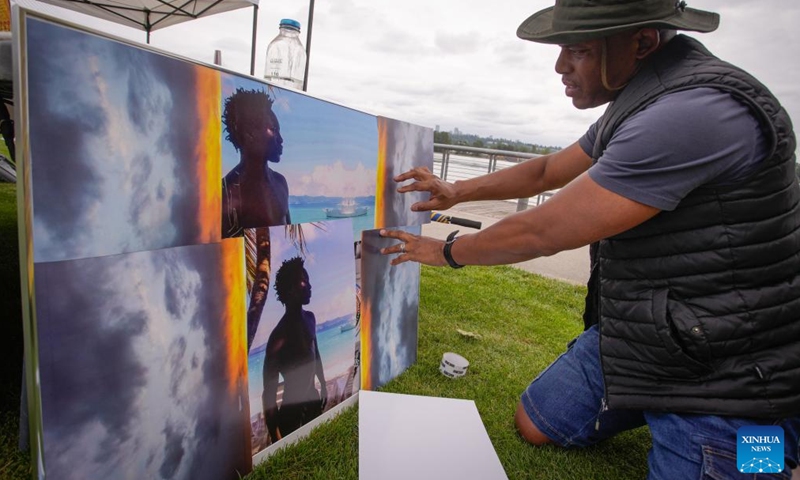 An artist showcases his works during the Afro World Expo in New Westminster, British Columbia, Canada, June 14, 2025. The event was held here Saturday, showcasing African culture through products, cuisine, music, and art, with the aim of enhancing community engagement and fostering cross-cultural understanding. (Photo: Xinhua)
