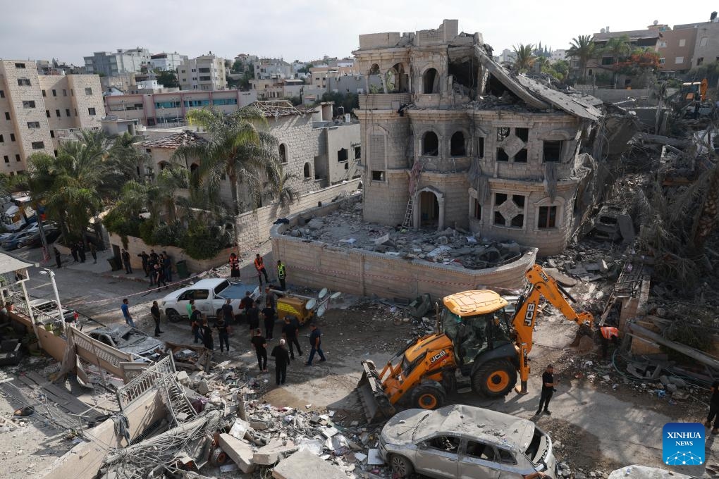 Israeli security and rescue forces work at a site hit by a missile fired from Iran in Tamra, Israel, June 15, 2025. The number of fatalities from a missile attack that hit Tamra, an Arab city in the North District of Israel, on Saturday night rose to four, according to the Magen David Adom (MDA) rescue service. They were identified as a mother and her two daughters and another relative. Dozens were injured. (Photo: Xinhua)