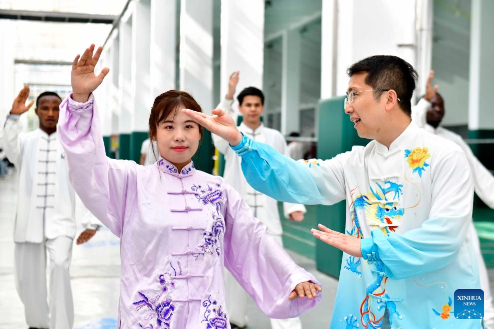 Zeela Nebulani (L front) practices Tai Chi following a teacher's instruction at the Rizhao Polytechnic in Rizhao City, east China's Shandong Province, May 23, 2025. (Photo: Xinhua)