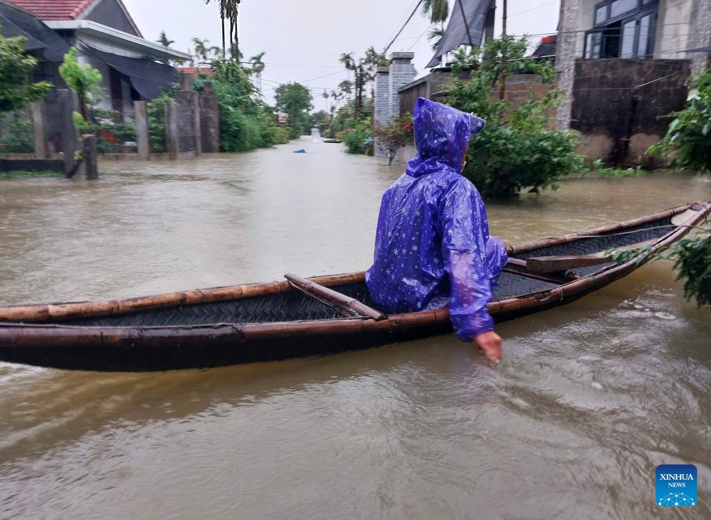 A person travels by boat in flood water in Hue city, central Vietnam, June 13, 2025. At least six people were killed and another remains missing in central Vietnam due to torrential rains and flooding triggered by Typhoon Wutip, the Vietnam Disaster and Dyke Management Authority said Sunday. (Photo: Xinhua)