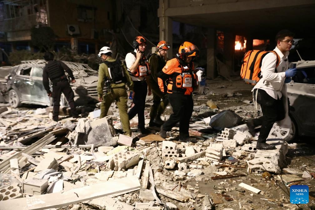 Israeli first responders work at a site hit by a missile fired from Iran in Bat Yam, south of Tel Aviv, Israel, June 15, 2025. Iranian aerial attacks killed at least six people and injured 140 others in Israel early on Sunday, Israeli authorities said. (Photo: Xinhua)
