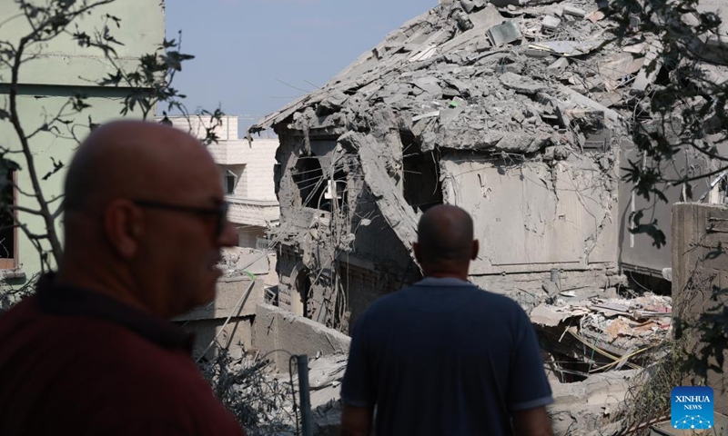People inspect buildings damaged during Iranian missile strike in Tamra, Israel, June 15, 2025. The number of fatalities from a missile attack that hit Tamra, an Arab city in the North District of Israel, on Saturday night rose to four, according to the Magen David Adom (MDA) rescue service. They were identified as a mother and her two daughters and another relative. Dozens were injured. (Photo: Xinhua)