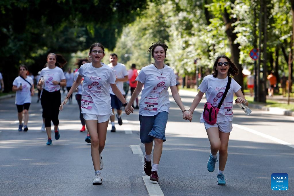 Participants run during the Race for the Cure, a part of an international fund-raising event aiming to fight breast cancer, in Bucharest, Romania, June 15, 2025. (Photo: Xinhua)