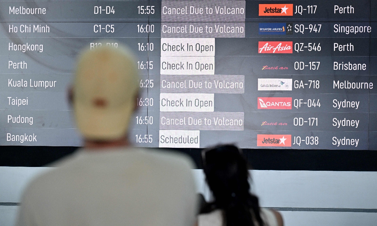 Passengers look at a board displaying canceled flights after the nearby Mount Lewotobi Laki-Laki volcano erupted, at Ngurah Rai International Airport in Tuban near Denpasar, on Indonesia's resort island of Bali on June 18, 2025. Dozens of flights were canceled on June 18, authorities said, after the volcano on Flores in the archipelago's east erupted, shooting an ash plume 10 kilometers into the sky.?Photo: VCG