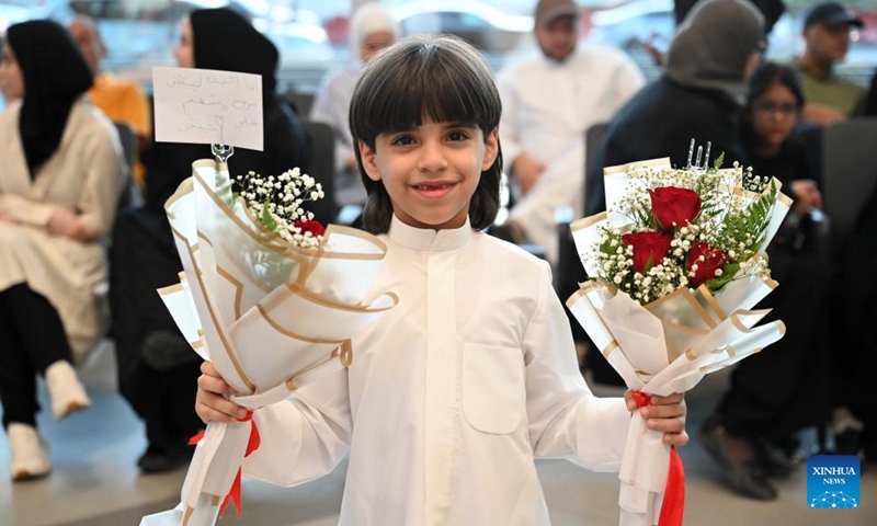 A boy holds flowers to welcome people evacuated from Iran at Kuwait International Airport in Farwaniya Governorate, Kuwait, June 21, 2025. The first batch of Kuwaiti citizens evacuated from Iran via Turkmenistan arrived in Kuwait on Saturday morning, as part of the ongoing efforts made by the Kuwait's Ministry of Foreign Affairs. (Photo: Xinhua)