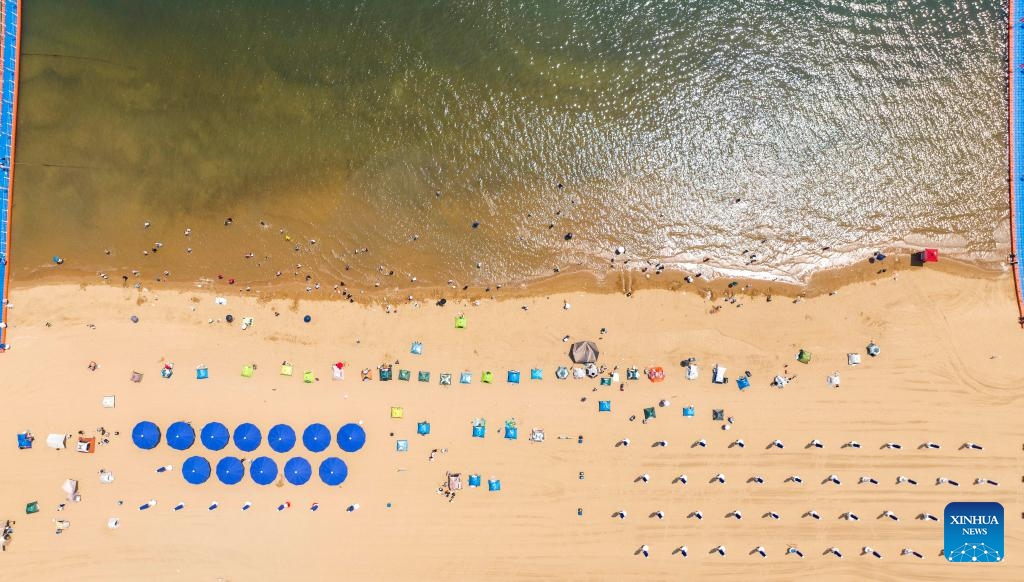 A drone photo taken on June 21, 2025 shows a beach in Binhai New Area of north China's Tianjin. In recent years, Binhai New Area in Tianjin has made great efforts to protect ecological environment and upgraded the layout of parks. Several seaside landmarks in Binhai have become popular tourist destinations. (Photo: Xinhua)