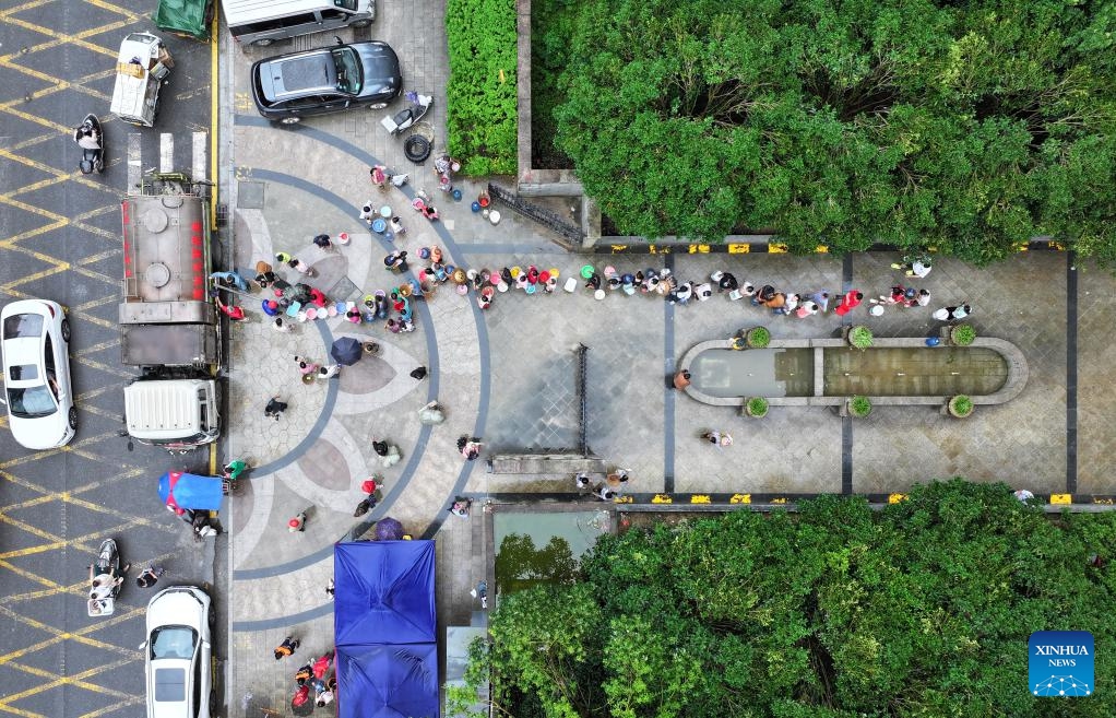 A drone photo taken on June 21, 2025 shows citizens fetching water in Longshan County, central China's Hunan Province. Torrential rainfall hit Longshan County in recent days. Disaster relief work is underway in the county as the rain weakened. (Photo: Xinhua)