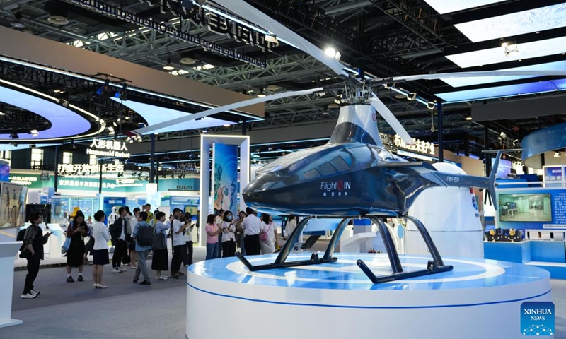 Visitors view a FWH-1500 unmanned helicopter at the Zhongguancun Exhibition Center in Beijing, capital of China, June 20, 2025. (Photo: Xinhua)