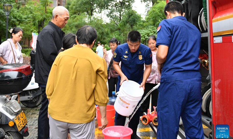 Citizens fetch water in Longshan County, central China's Hunan Province, June 21, 2025. Torrential rainfall hit Longshan County in recent days. Disaster relief work is underway in the county as the rain weakened. (Photo: Xinhua)