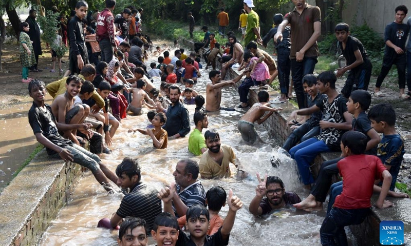 People cool off themselves during a heat wave in a canal in Lahore, Pakistan on June 20, 2025. Temperature reached over 40 degrees Celsius in many cities of Pakistan. (Photo: Xinhua)