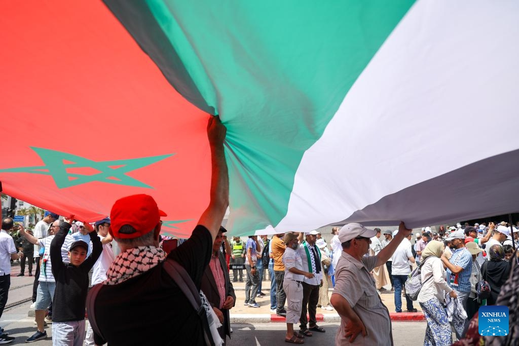 People hold Morocco and Palestine flags at a rally in support of Palestinians in Rabat, Morocco, June 22, 2025. Thousands of Moroccans gathered in downtown Rabat on Sunday to show solidarity with the Palestinian cause amid escalating regional tensions. (Photo: Xinhua)