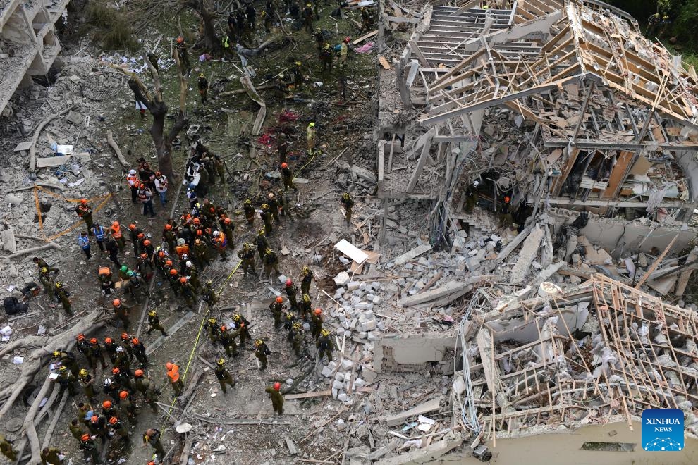 Israeli security and rescue forces work at the site of an Iranian missile attack in Tel Aviv, central Israel, on June 22, 2025. Ballistic missiles fired from Iran into central and northern Israel on Sunday morning wounded 26 people, two of whom in moderate condition, Israel's national emergency service Magen David Adom reported. Iran's Islamic Revolution Guards Corps on Sunday confirmed the attack, saying that the fresh wave of attacks targeted Ben Gurion Airport in Tel Aviv and a biological research center, among others. (Photo: Xinhua)