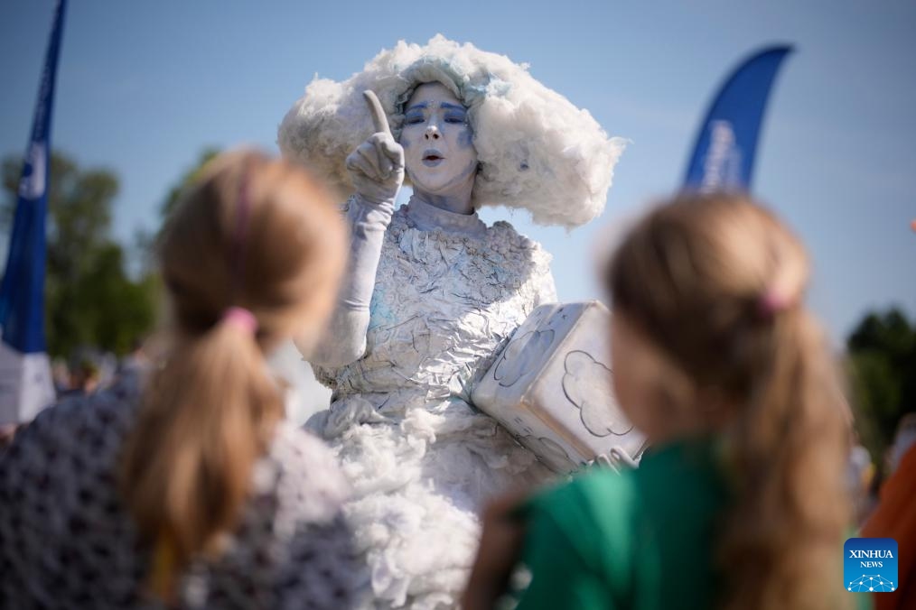 A performer in a cloud-shaped costume is seen during the Wianki Festival celebration in Warsaw, Poland, June 21, 2025. The event is a local tradition to mark the summer solstice, blending folklore, music, and modern festivities. (Photo: Xinhua)