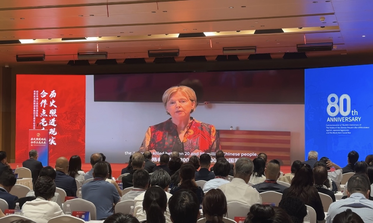 Nell Calloway, granddaughter of General Claire Chennault, delivers a video speech at a commemorative event titled 