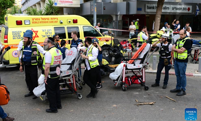 Israeli security and rescue forces work at the site of an Iranian missile attack in Tel Aviv, central Israel, on June 22, 2025. Ballistic missiles fired from Iran into central and northern Israel on Sunday morning wounded 26 people, two of whom in moderate condition, Israel's national emergency service Magen David Adom reported. Iran's Islamic Revolution Guards Corps on Sunday confirmed the attack, saying that the fresh wave of attacks targeted Ben Gurion Airport in Tel Aviv and a biological research center, among others. (Photo: Xinhua)