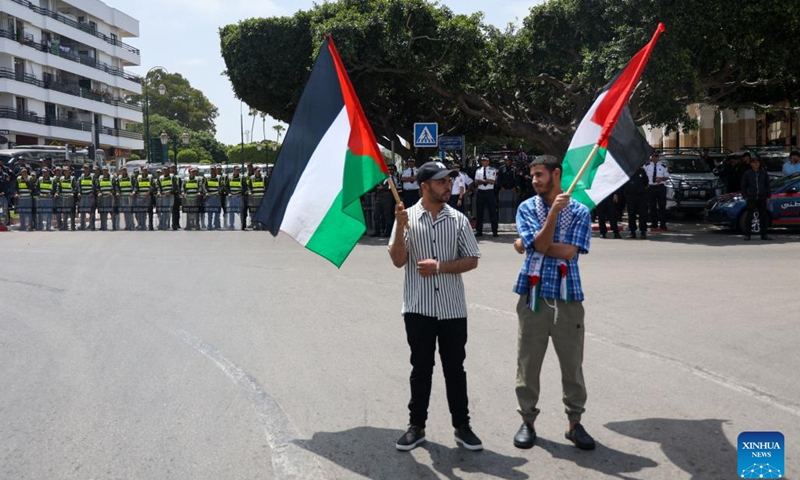 Two men hold Palestine flags at a rally in support of Palestinians in Rabat, Morocco, June 22, 2025. Thousands of Moroccans gathered in downtown Rabat on Sunday to show solidarity with the Palestinian cause amid escalating regional tensions. (Photo: Xinhua)