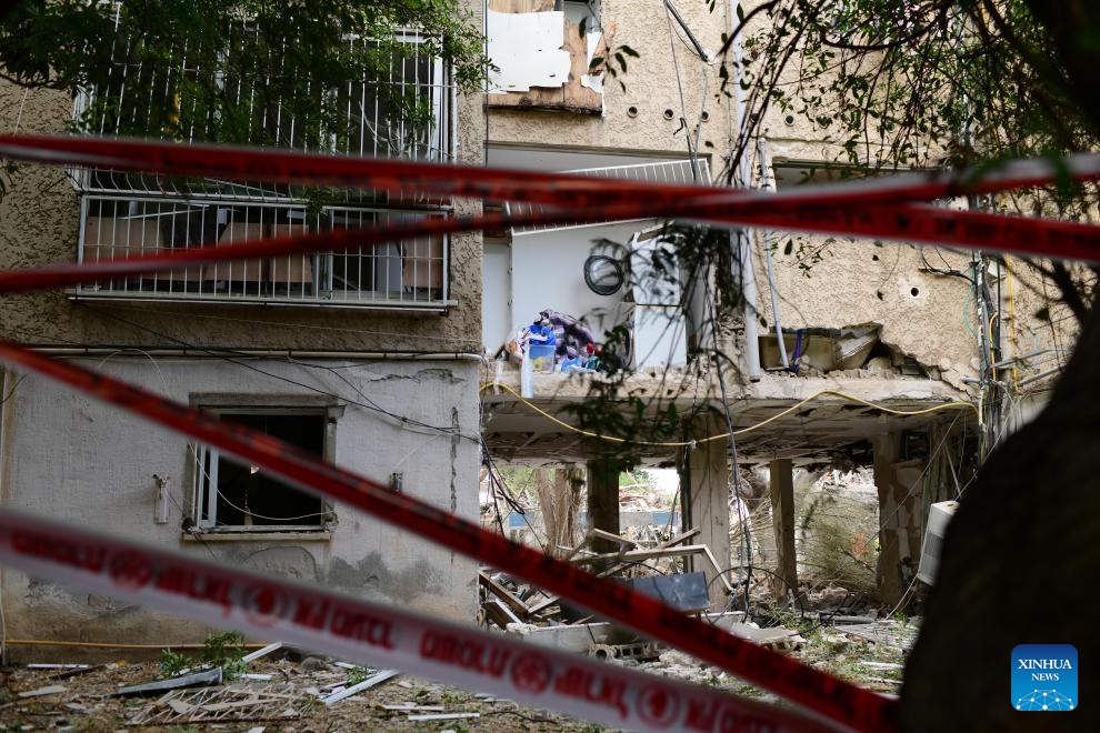 This photo taken on June 22, 2025 shows buildings damaged in an Iranian missile attack in Tel Aviv, central Israel. Ballistic missiles fired from Iran into central and northern Israel on Sunday morning wounded 26 people, two of whom in moderate condition, Israel's national emergency service Magen David Adom reported. (Photo: Xinhua)