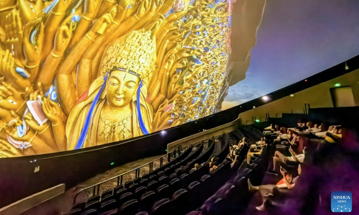 People watch an 8K dome theater movie at the Dazu Rock Carvings scenic spot in southwest China's Chongqing Municipality, June 24, 2025. Dazu Rock Carvings, a UNESCO World Heritage Site in southwest China's Chongqing Municipality, is being injected with new vigor as various digital technologies are used for its protection and utilization.

Technologies of AI, cloud computing, and big data, among others, were also applied to create 8K dome theater movies, VR experiences and programs alike to better entertain the tourists. (Xinhua/Tang Yi)