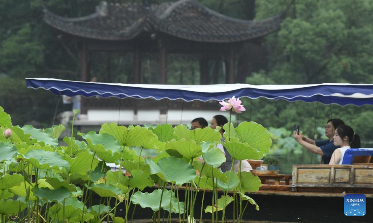 Tourists take a boat tour to view lotus flowers at the West Lake scenic spot in Hangzhou, east China's Zhejiang Province, June 24, 2025. Lotuses in the waters of the West Lake have entered the flowering period, which will last until early September. (Xinhua/Weng Xinyang)