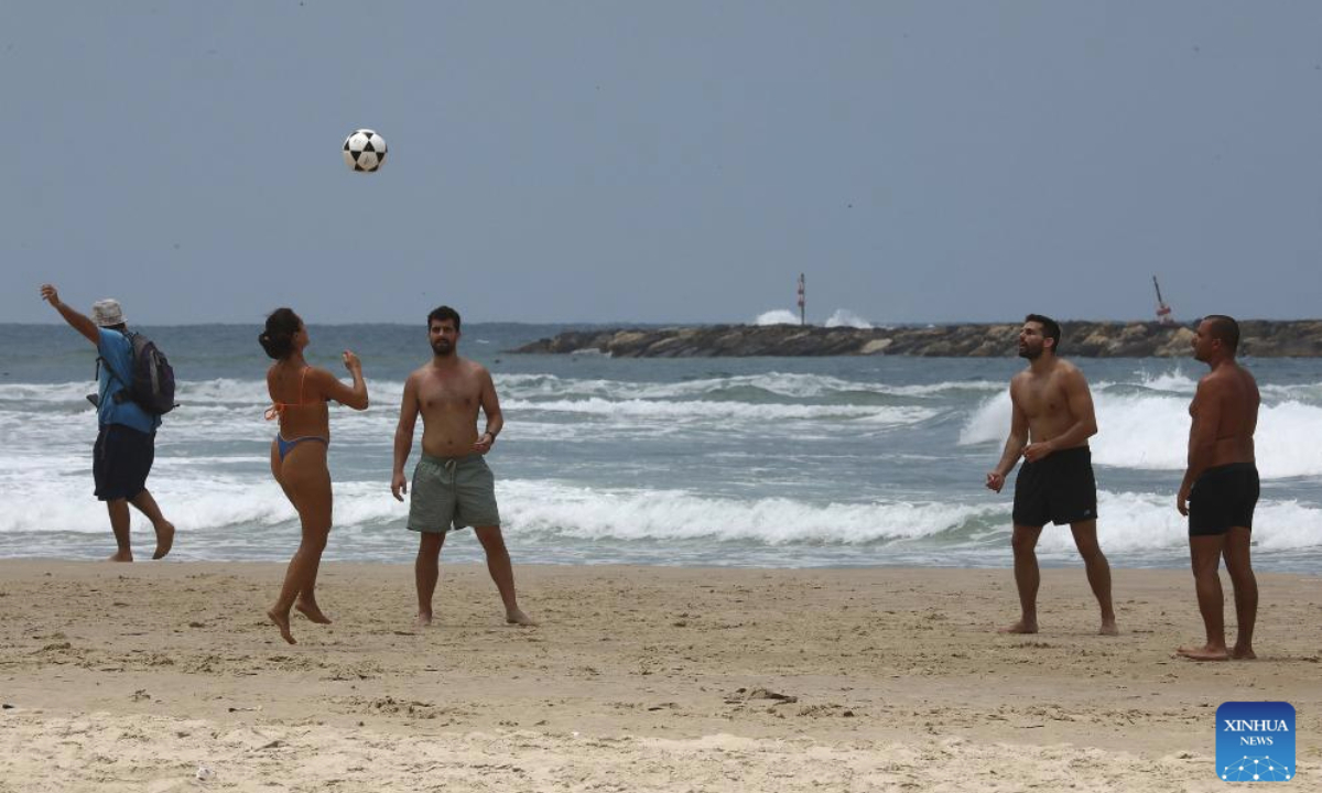 People enjoy themselves at a beach after a ceasefire between Iran and Israel took effect in Tel Aviv, central Israel, on June 24, 2025. (Gideon Markowicz/JINI via Xinhua)