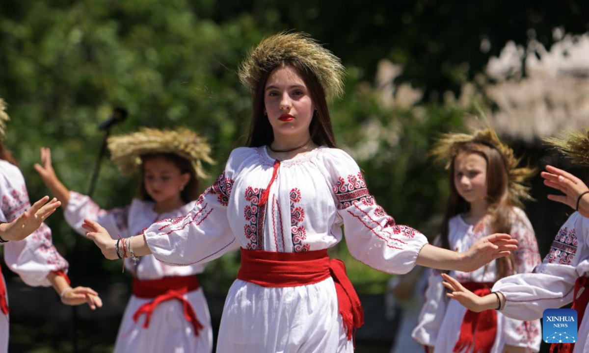 Girls dressed in traditional Romanian blouses perform during the Sanziene festival at the National Village Museum in Bucharest, Romania, June 24, 2025. According to traditions, fairies, called in Romanian Sanziene, descend to Earth around summer solstice to bring fertility to fields, love and good luck for the rest of the year. (Photo by Cristian Cristel/Xinhua)