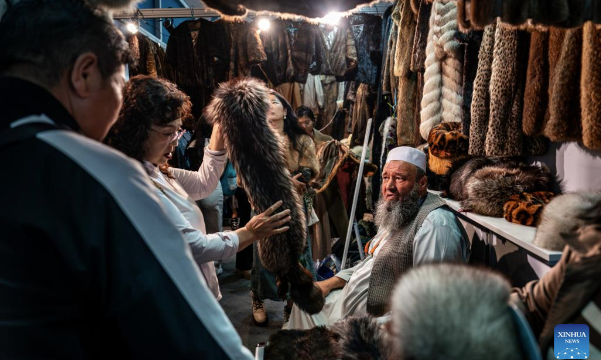 Visitors select Afghan products during the 9th China-South Asia Expo in Kunming, southwest China's Yunnan Province, June 24, 2025. The 9th China-South Asia Expo came to an end on Tuesday. A total of 153 agreements have been signed as of 12: 00 on June 24, with the total value of foreign trade contracts reaching 8.479 billion yuan (about 1.18 billion U.S. dollars). (Xinhua/Hu Chao)